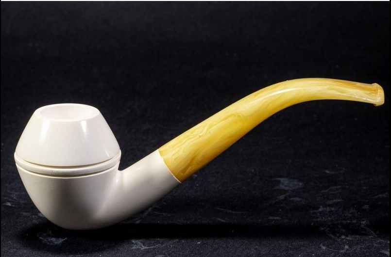Smooth Meerschaum Bent Bulldog pipe with a rounded white bowl and curved amber-colored stem on a dark background.